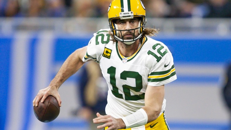 Jan 9, 2022; Detroit, Michigan, USA; Green Bay Packers quarterback Aaron Rodgers (12) runs the ball during the first quarter against the Detroit Lions at Ford Field. Mandatory Credit: Raj Mehta-USA TODAY Sports