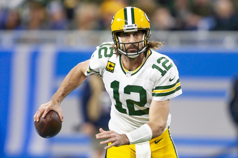Jan 9, 2022; Detroit, Michigan, USA; Green Bay Packers quarterback Aaron Rodgers (12) runs the ball during the first quarter against the Detroit Lions at Ford Field. Mandatory Credit: Raj Mehta-USA TODAY Sports