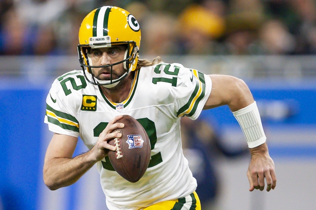 Jan 9, 2022; Detroit, Michigan, USA; Green Bay Packers quarterback Aaron Rodgers (12) runs the ball during the first quarter against the Detroit Lions at Ford Field. Mandatory Credit: Raj Mehta-USA TODAY Sports