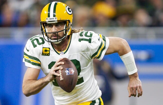 Jan 9, 2022; Detroit, Michigan, USA; Green Bay Packers quarterback Aaron Rodgers (12) runs the ball during the first quarter against the Detroit Lions at Ford Field. Mandatory Credit: Raj Mehta-USA TODAY Sports