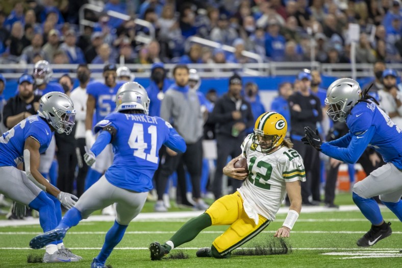 Jan 9, 2022; Detroit, Michigan, USA; Green Bay Packers quarterback Aaron Rodgers (12) runs with the ball against the Detroit Lions during the first half at Ford Field. Mandatory Credit: David Reginek-USA TODAY Sports
