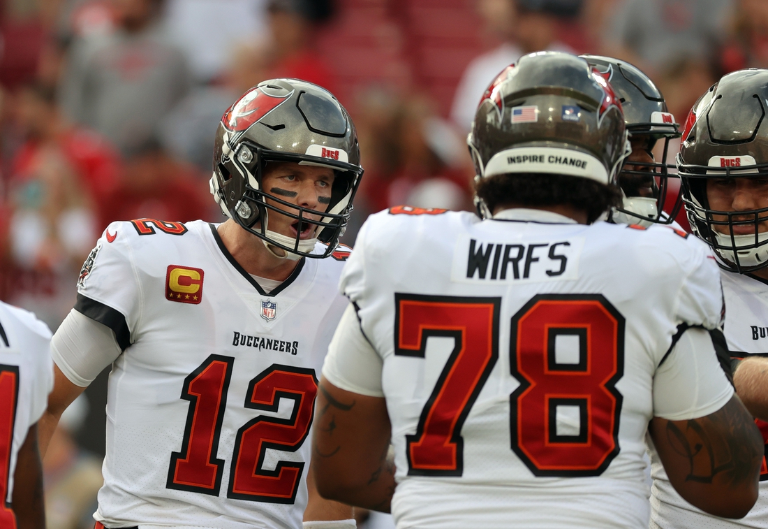 Jan 9, 2022; Tampa, Florida, USA; Tampa Bay Buccaneers quarterback Tom Brady (12) huddles up with offensive tackle Tristan Wirfs (78) against the Carolina Panthers prior to the game at Raymond James Stadium. Mandatory Credit: Kim Klement-USA TODAY Sports