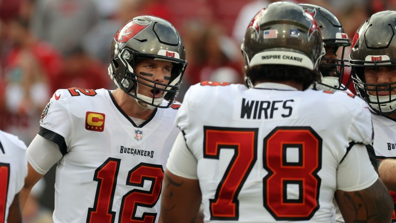 Jan 9, 2022; Tampa, Florida, USA; Tampa Bay Buccaneers quarterback Tom Brady (12) huddles up with offensive tackle Tristan Wirfs (78) against the Carolina Panthers prior to the game at Raymond James Stadium. Mandatory Credit: Kim Klement-USA TODAY Sports