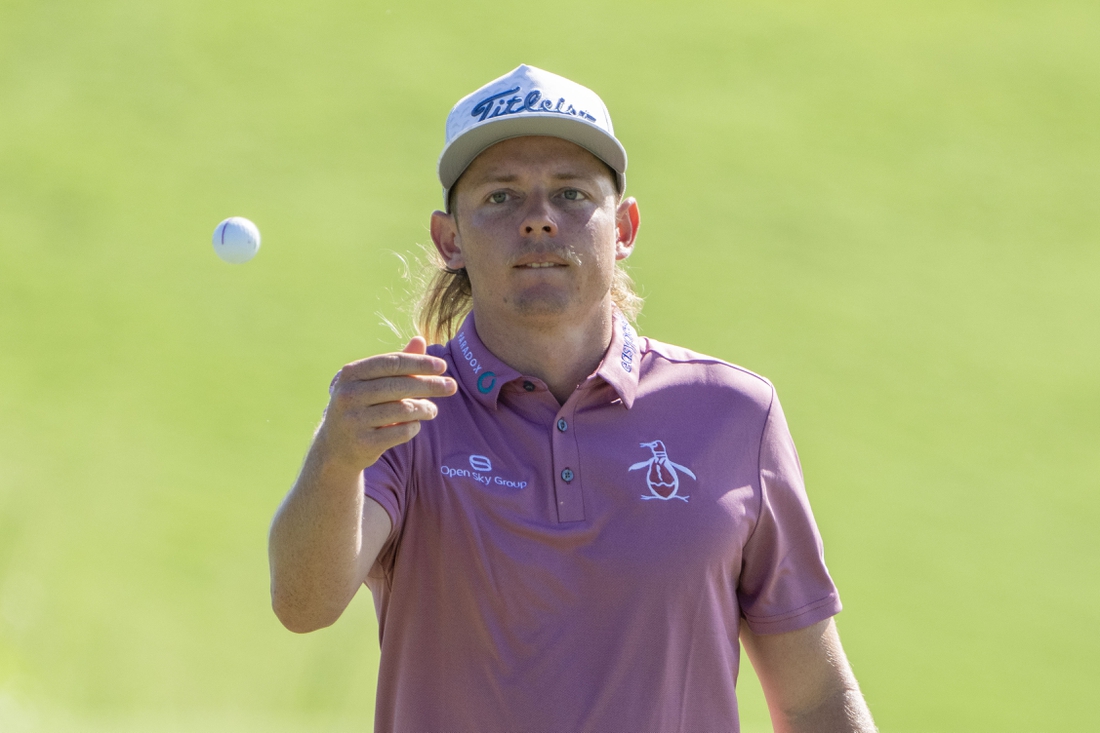 January 9, 2022; Maui, Hawaii, USA; Cameron Smith tosses his ball to his caddie on the first hole during the final round of the Sentry Tournament of Champions golf tournament at Kapalua Resort - The Plantation Course. Mandatory Credit: Kyle Terada-USA TODAY Sports