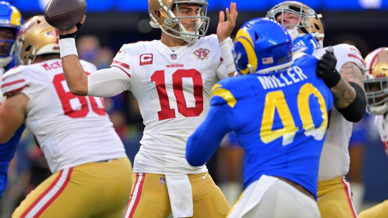 Jan 9, 2022; Inglewood, California, USA;  San Francisco 49ers quarterback Jimmy Garoppolo (10) sets to pass the ball in the first half of the game against the Los Angeles Rams at SoFi Stadium. Mandatory Credit: Jayne Kamin-Oncea-USA TODAY Sports