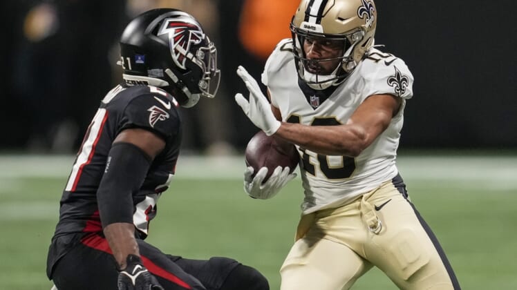 Jan 9, 2022; Atlanta, Georgia, USA; New Orleans Saints wide receiver Tre'Quan Smith (10) runs against Atlanta Falcons safety Duron Harmon (21) after a catch during the first half at Mercedes-Benz Stadium. Mandatory Credit: Dale Zanine-USA TODAY Sports
