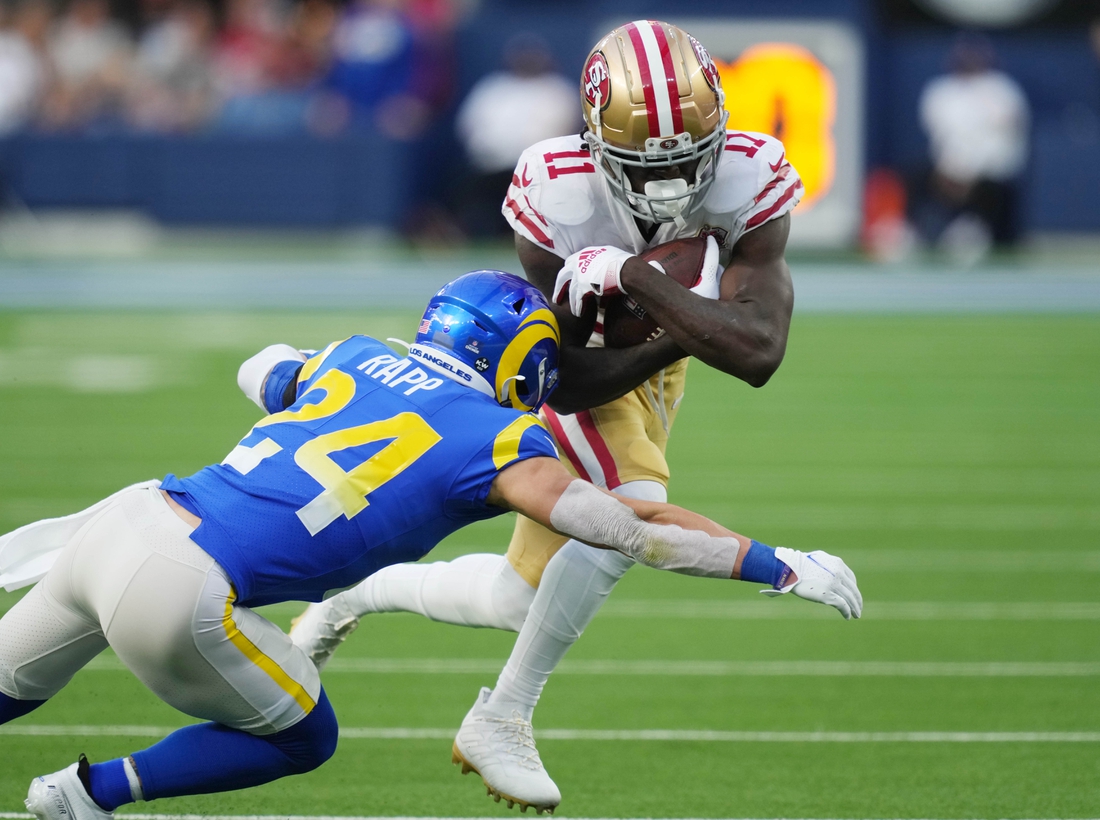 Jan 9, 2022; Inglewood, California, USA; San Francisco 49ers wide receiver Brandon Aiyuk (11) is tackled by Los Angeles Rams free safety Taylor Rapp (24) in the second half at SoFi Stadium. Mandatory Credit: Kirby Lee-USA TODAY Sports