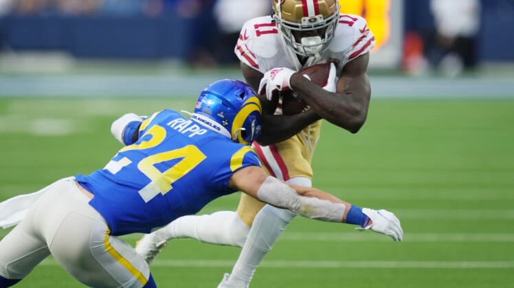 Jan 9, 2022; Inglewood, California, USA; San Francisco 49ers wide receiver Brandon Aiyuk (11) is tackled by Los Angeles Rams free safety Taylor Rapp (24) in the second half at SoFi Stadium. Mandatory Credit: Kirby Lee-USA TODAY Sports