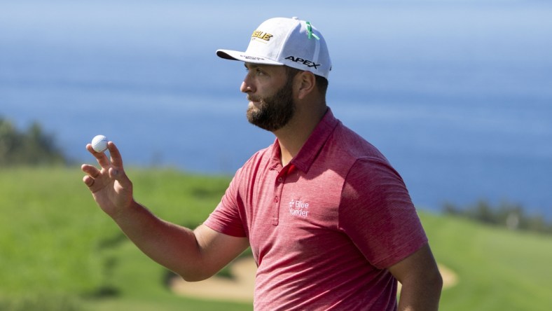 January 9, 2022; Maui, Hawaii, USA; Jon Rahm acknowledges the crowd after making his putt on the 13th hole during the final round of the Sentry Tournament of Champions golf tournament at Kapalua Resort - The Plantation Course. Mandatory Credit: Kyle Terada-USA TODAY Sports