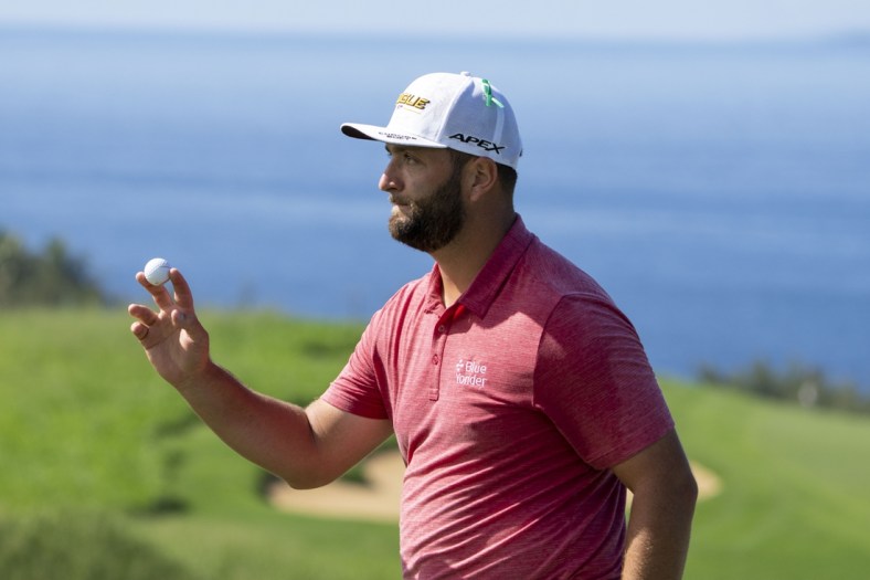 January 9, 2022; Maui, Hawaii, USA; Jon Rahm acknowledges the crowd after making his putt on the 13th hole during the final round of the Sentry Tournament of Champions golf tournament at Kapalua Resort - The Plantation Course. Mandatory Credit: Kyle Terada-USA TODAY Sports