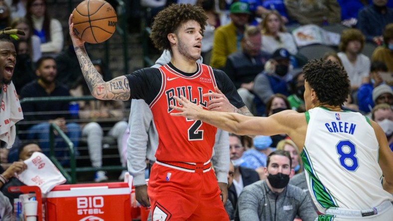 Jan 9, 2022; Dallas, Texas, USA; Chicago Bulls guard Lonzo Ball (2) looks to pass the ball by Dallas Mavericks guard Josh Green (8) during the second quarter at the American Airlines Center. Mandatory Credit: Jerome Miron-USA TODAY Sports