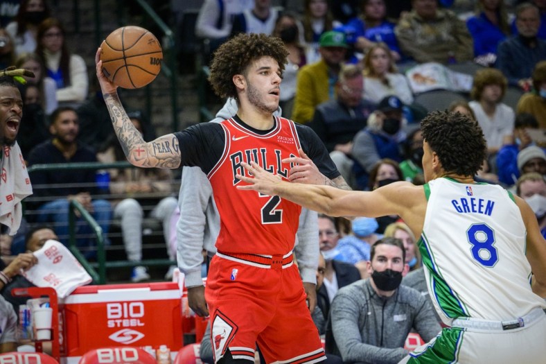 Jan 9, 2022; Dallas, Texas, USA; Chicago Bulls guard Lonzo Ball (2) looks to pass the ball by Dallas Mavericks guard Josh Green (8) during the second quarter at the American Airlines Center. Mandatory Credit: Jerome Miron-USA TODAY Sports