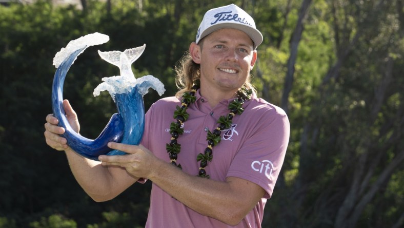 January 9, 2022; Maui, Hawaii, USA; Cameron Smith hoists the trophy after winning during the final round of the Sentry Tournament of Champions golf tournament at Kapalua Resort - The Plantation Course. Mandatory Credit: Kyle Terada-USA TODAY Sports