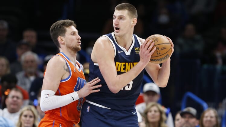 Jan 9, 2022; Oklahoma City, Oklahoma, USA; Denver Nuggets center Nikola Jokic (15) is defended by Oklahoma City Thunder center Mike Muscala (33) on a drive to the basket during the second half at Paycom Center. Denver won 99-95. Mandatory Credit: Alonzo Adams-USA TODAY Sports