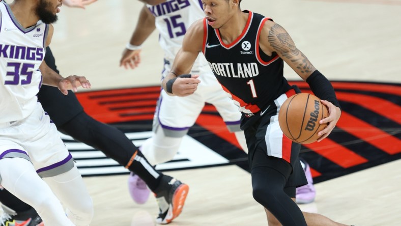 Jan 9, 2022; Portland, Oregon, USA;  Portland Trail Blazers guard Anfernee Simons (1) drives on Sacramento Kings forward Marvin Bagley III (35) in the second half at Moda Center. Mandatory Credit: Jaime Valdez-USA TODAY Sports