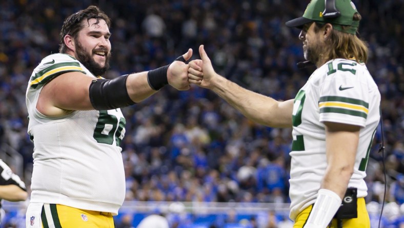 Jan 9, 2022; Detroit, Michigan, USA; Green Bay Packers center Lucas Patrick (62) celebrates with quarterback Aaron Rodgers (12) during the fourth quarter at Ford Field. Mandatory Credit: Raj Mehta-USA TODAY Sports