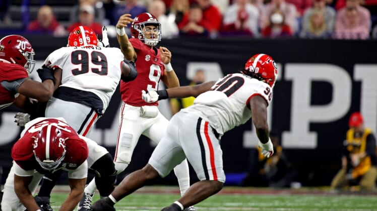 Jan 10, 2022; Indianapolis, IN, USA; Alabama Crimson Tide quarterback Bryce Young (9) throws a pass against Georgia Bulldogs defensive lineman Jordan Davis (99) during the second quarter in the 2022 CFP college football national championship game at Lucas Oil Stadium. Mandatory Credit: Trevor Ruszkowski-USA TODAY Sports