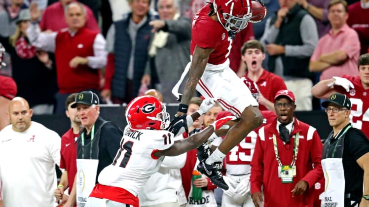 Jan 10, 2022; Indianapolis, IN, USA; Alabama Crimson Tide wide receiver Jameson Williams (1) tries to jumps over Georgia Bulldogs defensive back Derion Kendrick (11) during the first quarter in the 2022 CFP college football national championship game at Lucas Oil Stadium. Mandatory Credit: Mark J. Rebilas-USA TODAY Sports
