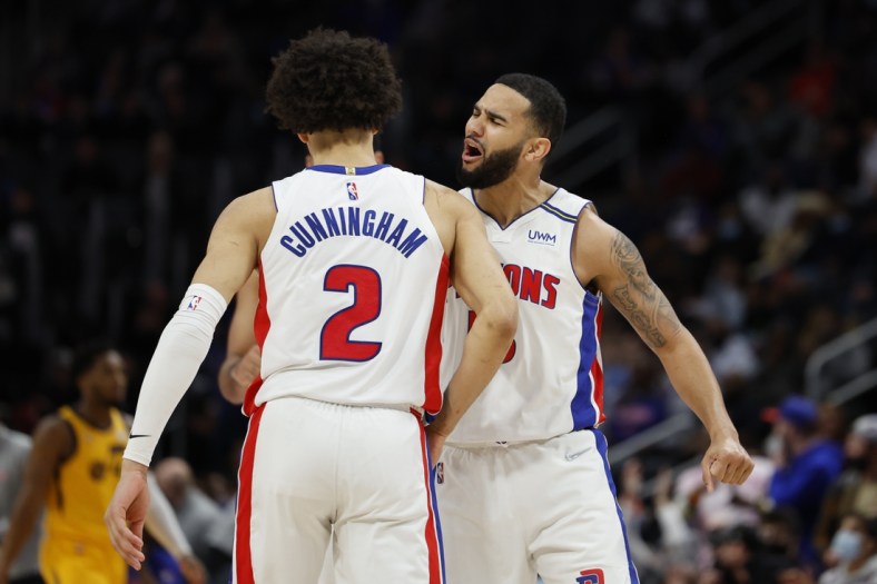 Jan 10, 2022; Detroit, Michigan, USA;  Detroit Pistons guard Cade Cunningham (2) receives congratulations from guard Cory Joseph (18) after he makes a three point basket in the second half against the Utah Jazz at Little Caesars Arena. Mandatory Credit: Rick Osentoski-USA TODAY Sports