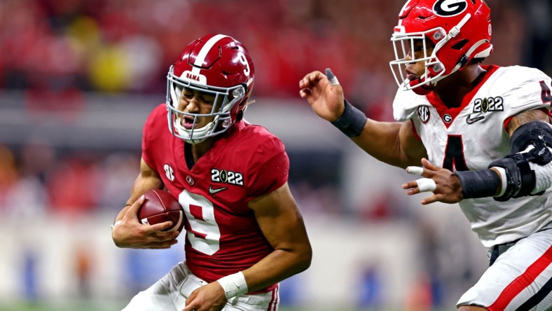 Jan 10, 2022; Indianapolis, IN, USA; Alabama Crimson Tide quarterback Bryce Young (9) runs the ball against Georgia Bulldogs linebacker Nolan Smith (4) during the second half in the 2022 CFP college football national championship game at Lucas Oil Stadium. Mandatory Credit: Mark J. Rebilas-USA TODAY Sports