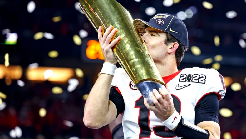 Jan 10, 2022; Indianapolis, IN, USA; Georgia Bulldogs quarterback Stetson Bennett (13) celebrates after the Georgia Bulldogs beat the Alabama Crimson Tide in the 2022 CFP college football national championship game at Lucas Oil Stadium. Mandatory Credit: Mark J. Rebilas-USA TODAY Sports