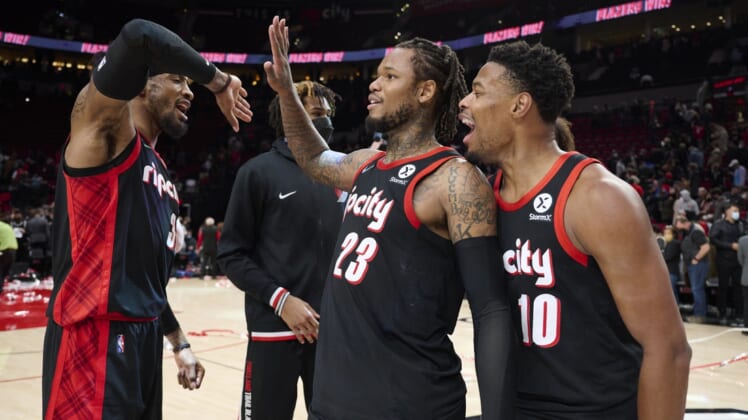 Jan 10, 2022; Portland, Oregon, USA; Portland Trail Blazers forward Robert Covington (33) celebrates with guard Ben McLemore (23) and guard Dennis Smith Jr. (10) after a game against the Brooklyn Nets at Moda Center. The Trail Blazers won the game 114-108. Mandatory Credit: Troy Wayrynen-USA TODAY Sports