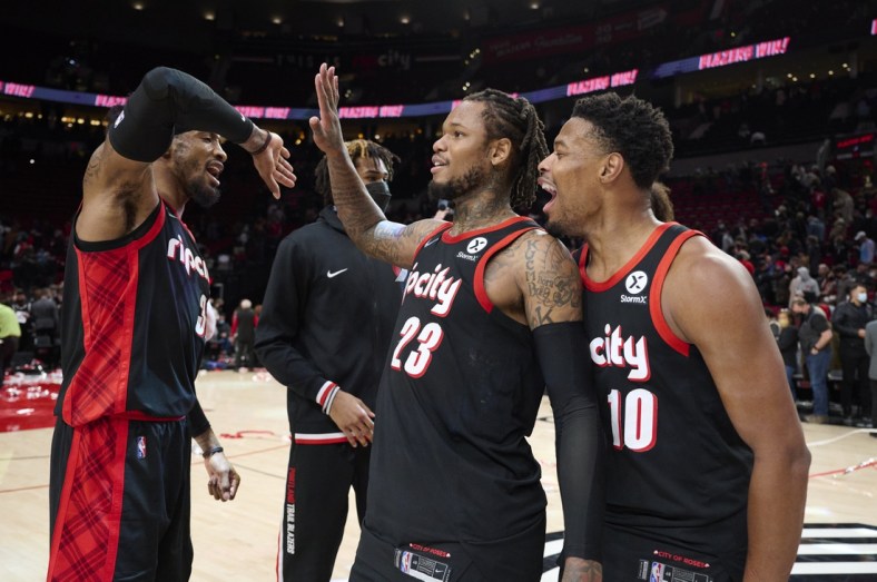 Jan 10, 2022; Portland, Oregon, USA; Portland Trail Blazers forward Robert Covington (33) celebrates with guard Ben McLemore (23) and guard Dennis Smith Jr. (10) after a game against the Brooklyn Nets at Moda Center. The Trail Blazers won the game 114-108. Mandatory Credit: Troy Wayrynen-USA TODAY Sports