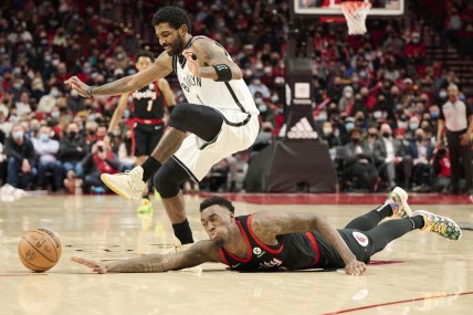 Jan 10, 2022; Portland, Oregon, USA; Portland Trail Blazers forward Nassir Little (9) dives for a loose ball during the second half against Brooklyn Nets guard Kyrie Irving (11) at Moda Center. The Trail Blazers won the game 114-108. Mandatory Credit: Troy Wayrynen-USA TODAY Sports