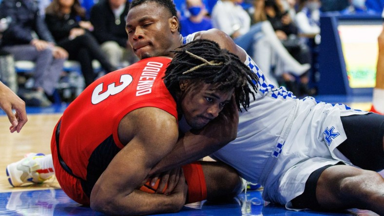 Jan 8, 2022; Lexington, Kentucky, USA; Georgia Bulldogs guard Kario Oquendo (3) and Kentucky Wildcats forward Oscar Tshiebwe (34) fight for the ball during the second half at Rupp Arena at Central Bank Center. Mandatory Credit: Jordan Prather-USA TODAY Sports