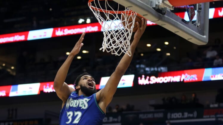 Jan 11, 2022; New Orleans, Louisiana, USA; Minnesota Timberwolves center Karl-Anthony Towns (32) shoots a layup in the first quarter against the New Orleans Pelicans at the Smoothie King Center. Mandatory Credit: Chuck Cook-USA TODAY Sports