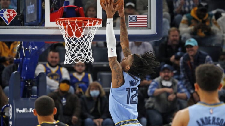 Jan 11, 2022; Memphis, Tennessee, USA; Memphis Grizzles guard Ja Morant (12) dunks the ball during the first half against the Golden State Warriors at FedExForum. Mandatory Credit: Petre Thomas-USA TODAY Sports