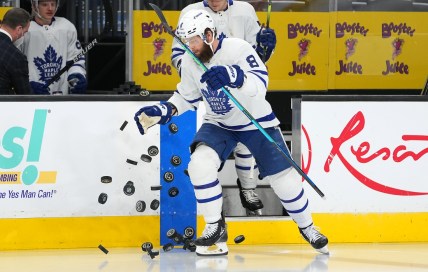 Jan 11, 2022; Las Vegas, Nevada, USA; Toronto Maple Leafs defenseman Jake Muzzin (8) tosses practice pucks onto the ice before the start of a game against the Vegas Golden Knights at T-Mobile Arena. Mandatory Credit: Stephen R. Sylvanie-USA TODAY Sports