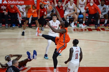 Jan 11, 2022; Lincoln, Nebraska, USA;  Illinois Fighting Illini center Kofi Cockburn (21) is called for an offensive foul against Nebraska Cornhuskers guard Alonzo Verge Jr. (1) on a dunk in the first half at Pinnacle Bank Arena. Mandatory Credit: Steven Branscombe-USA TODAY Sports