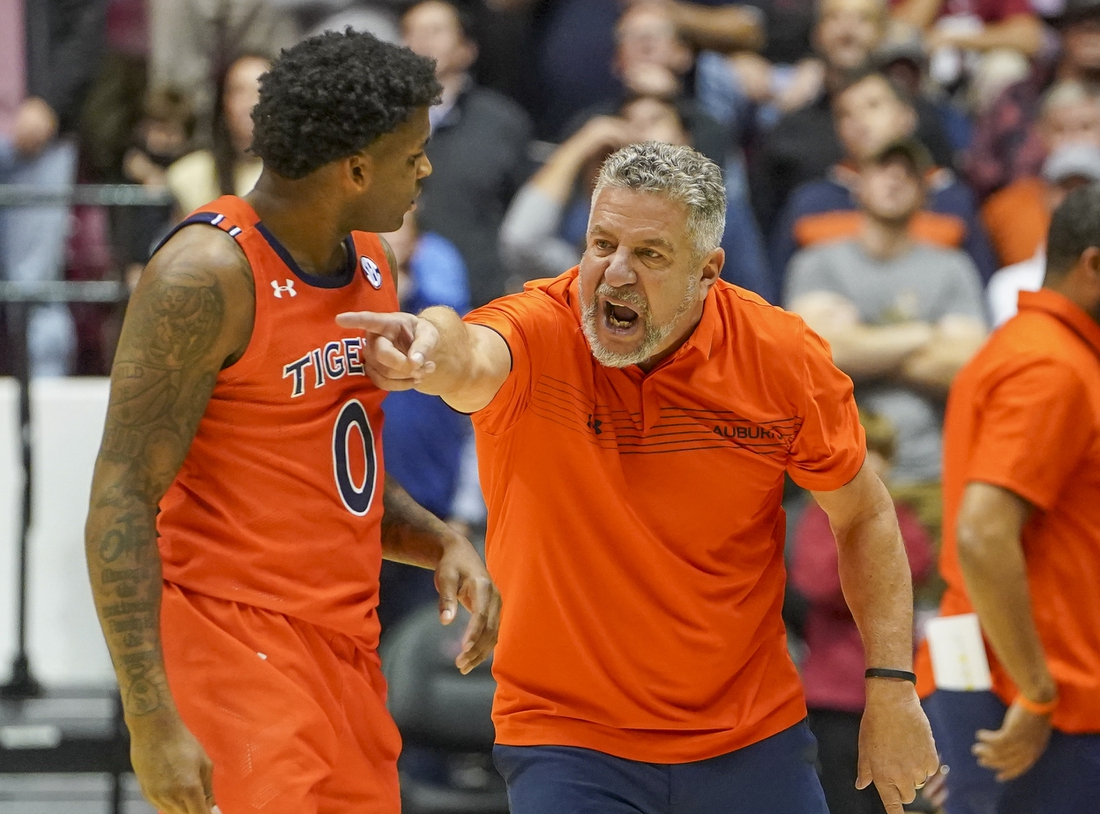 Jan 11, 2022; Tuscaloosa, Alabama, USA; Auburn Tigers head coach Bruce Pearl talks to Auburn Tigers guard K.D. Johnson (0) during the second half against Alabama Crimson Tide at Coleman Coliseum. Mandatory Credit: Marvin Gentry-USA TODAY Sports