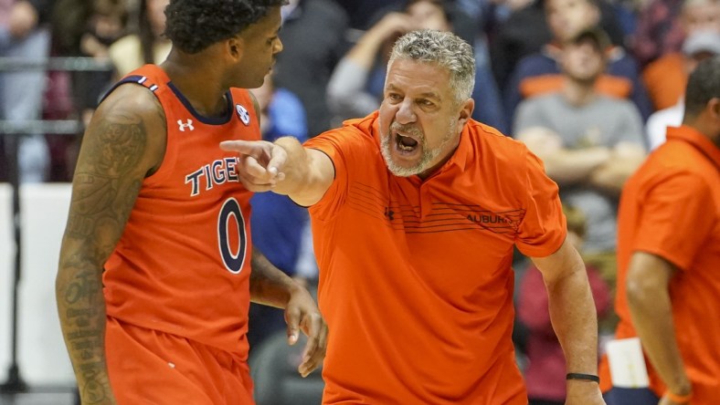 Jan 11, 2022; Tuscaloosa, Alabama, USA; Auburn Tigers head coach Bruce Pearl talks to Auburn Tigers guard K.D. Johnson (0) during the second half against Alabama Crimson Tide at Coleman Coliseum. Mandatory Credit: Marvin Gentry-USA TODAY Sports