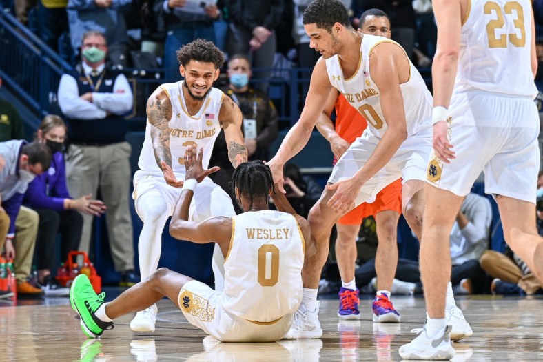 Jan 12, 2022; South Bend, Indiana, USA; Notre Dame Fighting Irish guard Blake Wesley (0) is helped up by guard Prentiss Hubb (3) and forward Paul Atkinson Jr. (20) after he was fouled in the first half against the Clemson Tigers at the Purcell Pavilion. Mandatory Credit: Matt Cashore-USA TODAY Sports