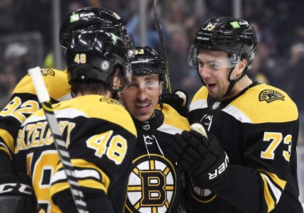 Jan 12, 2022; Boston, Massachusetts, USA; Boston Bruins left wing Brad Marchand (63) celebrates his goal with defenseman Charlie McAvoy (73) and defenseman Matt Grzelcyk (48) and left wing Tomas Nosek (92) during the first period against the Montreal Canadiens at TD Garden. Mandatory Credit: Bob DeChiara-USA TODAY Sports