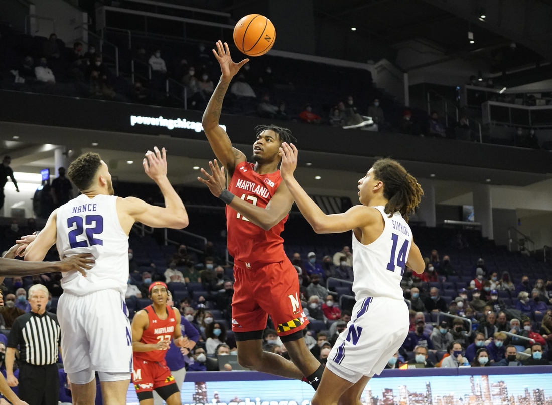 Jan 12, 2022; Evanston, Illinois, USA; Maryland Terrapins guard Hakim Hart (13) shoots over Northwestern Wildcats forward Pete Nance (22) during the first half at Welsh-Ryan Arena. Mandatory Credit: David Banks-USA TODAY Sports