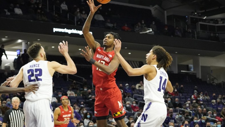 Jan 12, 2022; Evanston, Illinois, USA; Maryland Terrapins guard Hakim Hart (13) shoots over Northwestern Wildcats forward Pete Nance (22) during the first half at Welsh-Ryan Arena. Mandatory Credit: David Banks-USA TODAY Sports