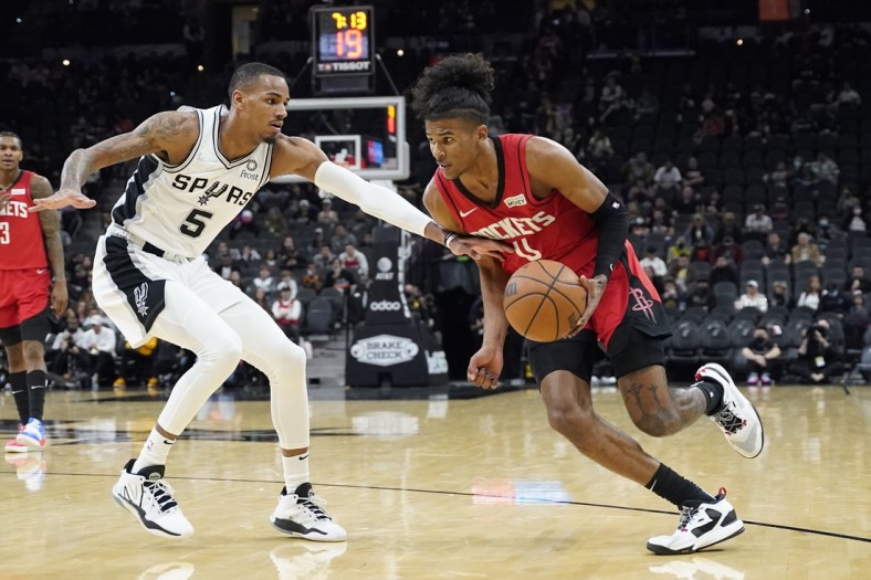 Jan 12, 2022; San Antonio, Texas, USA; Houston Rockets guard Jalen Green (0) moves to the basket while defended by San Antonio Spurs guard Dejounte Murray (5) during the second half at AT&T Center. Mandatory Credit: Scott Wachter-USA TODAY Sports