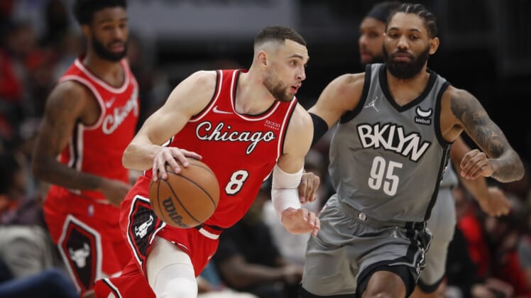 Jan 12, 2022; Chicago, Illinois, USA; Chicago Bulls guard Zach LaVine (8) dribbles the ball while defended by Brooklyn Nets guard DeAndre' Bembry (95) during the second half at United Center. Mandatory Credit: Kamil Krzaczynski-USA TODAY Sports