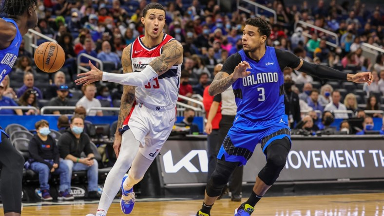 Jan 9, 2022; Orlando, Florida, USA; Washington Wizards forward Kyle Kuzma (33) passes the ball against Orlando Magic forward Chuma Okeke (3) during the second quarter at Amway Center. Mandatory Credit: Mike Watters-USA TODAY Sports