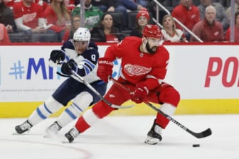 Jan 13, 2022; Detroit, Michigan, USA;  Detroit Red Wings defenseman Nick Leddy (2) skates with the puck chased by Winnipeg Jets center Andrew Copp (9) in the first period at Little Caesars Arena. Mandatory Credit: Rick Osentoski-USA TODAY Sports