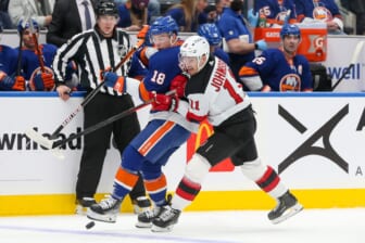 Jan 13, 2022; Elmont, New York, USA; New York Islanders left wing Anthony Beauvillier (18) and New Jersey Devils left wing Andreas Johnsson (11) battle for the puck during the first period at UBS Arena. Mandatory Credit: Tom Horak-USA TODAY Sports