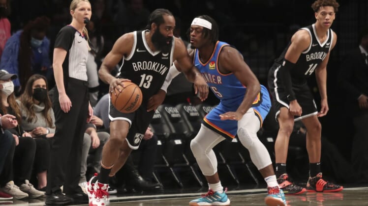 Jan 13, 2022; Brooklyn, New York, USA;  Brooklyn Nets guard James Harden (13) looks to drive past Oklahoma City Thunder forward Luguentz Dort (5) in the first quarter at Barclays Center. Mandatory Credit: Wendell Cruz-USA TODAY Sports