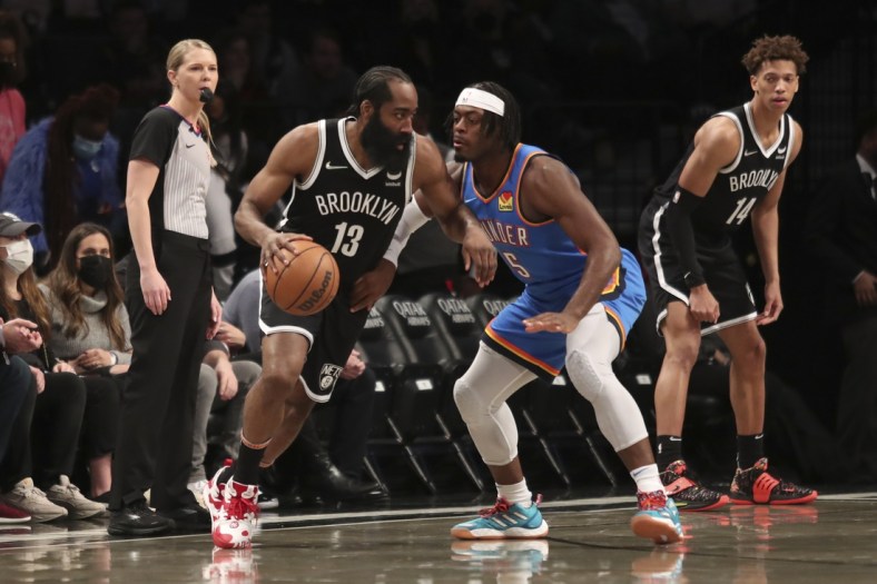 Jan 13, 2022; Brooklyn, New York, USA;  Brooklyn Nets guard James Harden (13) looks to drive past Oklahoma City Thunder forward Luguentz Dort (5) in the first quarter at Barclays Center. Mandatory Credit: Wendell Cruz-USA TODAY Sports