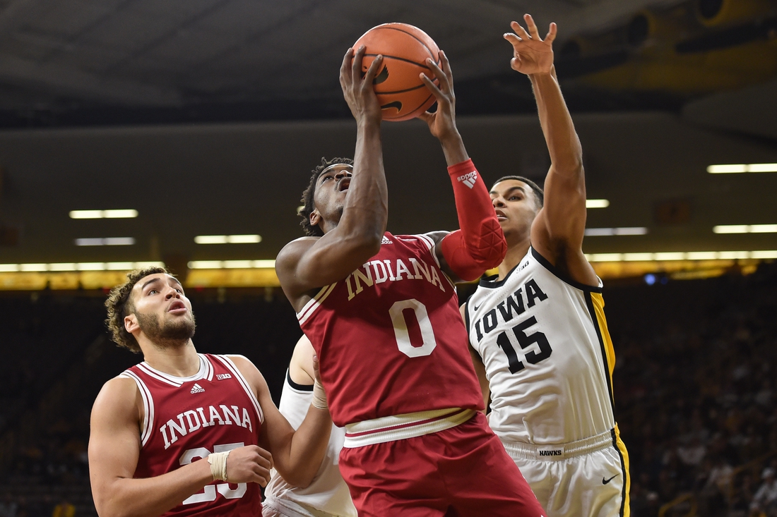 Jan 13, 2022; Iowa City, Iowa, USA; Indiana Hoosiers guard Xavier Johnson (0) goes to the basket as forward Trayce Jackson-Davis (23) looks on and Iowa Hawkeyes forward Keegan Murray (15) defends during the first half at Carver-Hawkeye Arena. Mandatory Credit: Jeffrey Becker-USA TODAY Sports