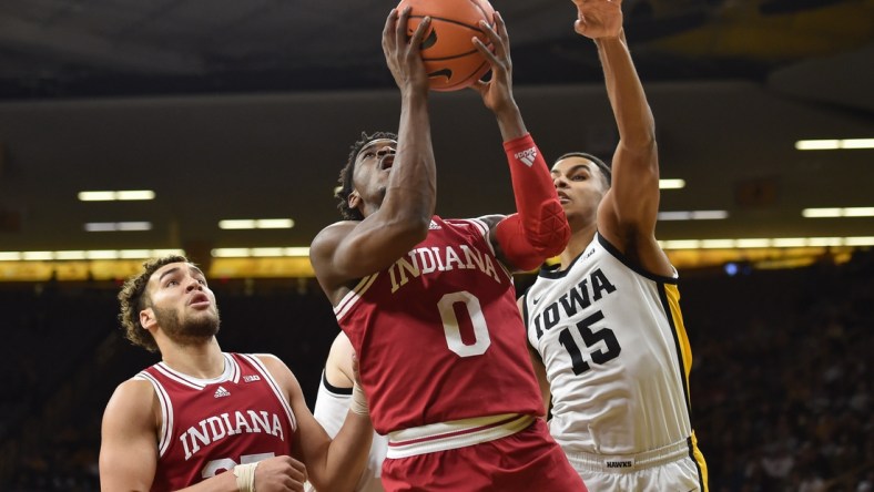 Jan 13, 2022; Iowa City, Iowa, USA; Indiana Hoosiers guard Xavier Johnson (0) goes to the basket as forward Trayce Jackson-Davis (23) looks on and Iowa Hawkeyes forward Keegan Murray (15) defends during the first half at Carver-Hawkeye Arena. Mandatory Credit: Jeffrey Becker-USA TODAY Sports