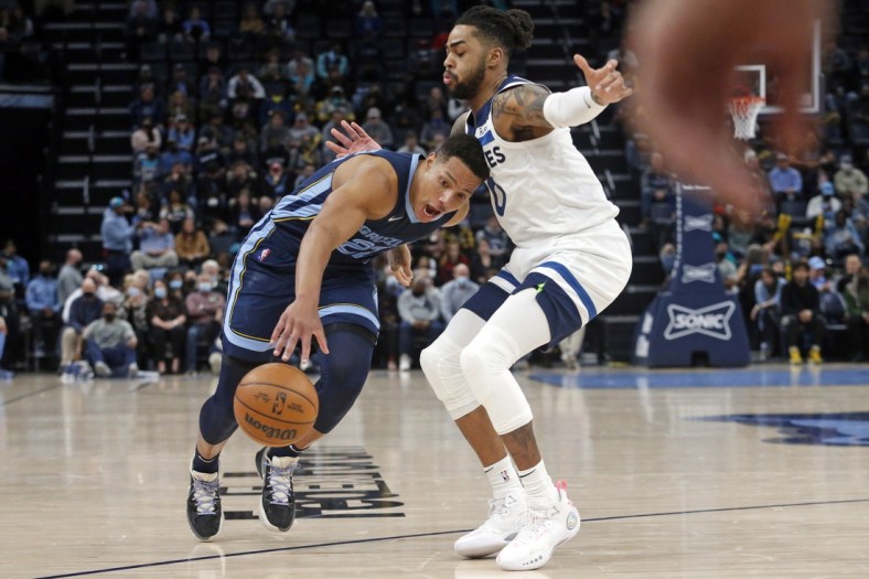 Jan 13, 2022; Memphis, Tennessee, USA; Memphis Grizzles guard Desmond Bane (22) drives to the basket as Minnesota Timberwolves guard D'Angelo Russell (0) defends during the second half at FedExForum. Mandatory Credit: Petre Thomas-USA TODAY Sports