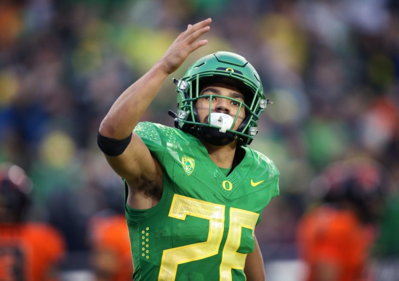 Oregon RB Travis Dye acknowledges the crowd after scoring against Oregon State in the second half.

Eug 111428 Uofb 01
